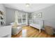 Bright Bedroom with hardwood floors, a white crib, comfortable chair, and natural light from a large window at 106 Bluefield Rd, Chapel Hill, NC 27517