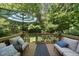 Inviting deck with outdoor seating and umbrella, nestled in a lush, green backyard oasis at 106 Bluefield Rd, Chapel Hill, NC 27517