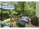 Relaxing deck with seating, an umbrella, and views of the lush backyard at 106 Bluefield Rd, Chapel Hill, NC 27517