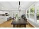 Bright dining room with hardwood floors, large windows, and modern light fixture at 106 Bluefield Rd, Chapel Hill, NC 27517