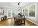 Bright dining room with hardwood floors, large windows, and modern light fixture at 106 Bluefield Rd, Chapel Hill, NC 27517