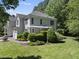 Charming two-story home boasts lush landscaping and a welcoming pergola-covered entrance at 106 Bluefield Rd, Chapel Hill, NC 27517