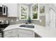 Bright kitchen featuring a stainless steel sink beneath a window with natural light at 106 Bluefield Rd, Chapel Hill, NC 27517