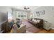 Cozy living room with hardwood floors, a ceiling fan, and plenty of natural light at 106 Bluefield Rd, Chapel Hill, NC 27517