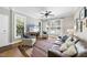 Cozy living room with hardwood floors, a ceiling fan, and plenty of natural light at 106 Bluefield Rd, Chapel Hill, NC 27517