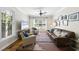 Cozy living room with hardwood floors, a ceiling fan, and plenty of natural light at 106 Bluefield Rd, Chapel Hill, NC 27517