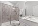 Bathroom featuring a marble tiled shower, white cabinets, and a large vanity sink at 108 Valley View Dr, Chapel Hill, NC 27516
