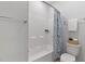 Clean, bright full bath with a tub and shower combo and gray tile flooring at 108 Valley View Dr, Chapel Hill, NC 27516