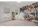 Bright bedroom featuring a jungle-themed accent wall, a play teepee, and sunlit windows at 108 Valley View Dr, Chapel Hill, NC 27516