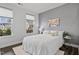 Cozy bedroom with white bedding, gray accent wall, and natural light at 108 Valley View Dr, Chapel Hill, NC 27516