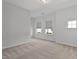 Spacious bedroom with plush carpeting and multiple windows that provide ample natural light at 108 Valley View Dr, Chapel Hill, NC 27516