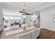 Dining area featuring hardwood floors, modern light fixture, and views into the kitchen and living room at 108 Valley View Dr, Chapel Hill, NC 27516