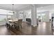 Open-concept dining room with wood floors and neutral color palette and views into the living room at 108 Valley View Dr, Chapel Hill, NC 27516