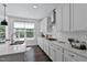 Sleek kitchen with white cabinetry, stainless steel appliances, and a large island with plenty of counter space at 108 Valley View Dr, Chapel Hill, NC 27516