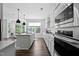 Modern kitchen featuring white cabinets, stainless steel appliances, and a spacious island with seating at 108 Valley View Dr, Chapel Hill, NC 27516