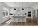 Modern kitchen with white cabinetry, stainless steel appliances, a center island, and pendant lighting at 108 Valley View Dr, Chapel Hill, NC 27516