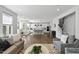 Bright, open-concept living room featuring modern furnishings, hardwood floors, and a stylish staircase at 108 Valley View Dr, Chapel Hill, NC 27516