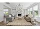 Comfortable living room featuring stylish seating, a decorative fireplace, and built-in shelving at 108 Valley View Dr, Chapel Hill, NC 27516