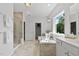 Bright main bathroom featuring a garden tub, separate shower, double vanity sinks, and large windows at 108 Valley View Dr, Chapel Hill, NC 27516