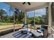 Inviting screened porch with comfortable wicker seating and a view of the manicured backyard at 108 Valley View Dr, Chapel Hill, NC 27516
