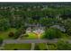 Aerial view of home on large lot with lake, lush trees and other homes in neighborhood at 1093 N Lakeside Dr, Smithfield, NC 27577