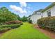 Lush backyard with manicured lawn, mature landscaping, and a patio area, perfect for outdoor activities at 1093 N Lakeside Dr, Smithfield, NC 27577