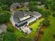 Aerial view of a beautiful home featuring a large patio, perfectly manicured lawn, and extensive landscaping at 1093 N Lakeside Dr, Smithfield, NC 27577