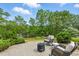 Private backyard patio featuring comfortable seating, fire pit, mature landscaping, and scenic lake views at 1093 N Lakeside Dr, Smithfield, NC 27577
