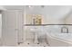 Traditional bathroom featuring a pedestal sink, soaking tub, black and white tile and wainscoting at 1093 N Lakeside Dr, Smithfield, NC 27577