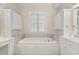 A spacious bathroom displays the bathtub set beneath a window flanked by built-in cabinets at 1093 N Lakeside Dr, Smithfield, NC 27577
