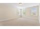 Bright bedroom featuring neutral carpet and three large windows for ample natural light at 1093 N Lakeside Dr, Smithfield, NC 27577