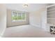 Bedroom with a window, a built-in bookshelf and carpet at 1093 N Lakeside Dr, Smithfield, NC 27577