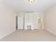 Bright bedroom featuring neutral carpet, built-in desk and a view to the bathroom at 1093 N Lakeside Dr, Smithfield, NC 27577