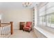 Upstairs bonus room with natural light, stylish chair, and built in shelves at 1093 N Lakeside Dr, Smithfield, NC 27577