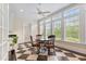 Eat-in kitchen nook featuring a ceiling fan, black and white tile flooring, and multiple windows at 1093 N Lakeside Dr, Smithfield, NC 27577
