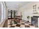 A bright kitchen breakfast nook with black and white floors, a ceiling fan, and black french doors at 1093 N Lakeside Dr, Smithfield, NC 27577