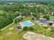Aerial view of the community pool surrounded by lush landscaping, and recreational facilities, great for relaxation at 1093 N Lakeside Dr, Smithfield, NC 27577