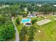 Aerial view of the community pool, clubhouse, and surrounding golf course, offering a luxurious lifestyle at 1093 N Lakeside Dr, Smithfield, NC 27577