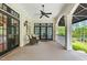 Charming covered porch with neutral furnishings, ceiling fan and black framed glass doors enhancing its elegance at 1093 N Lakeside Dr, Smithfield, NC 27577
