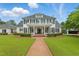 Stunning two-story home with a manicured lawn, brick walkway, and classic architectural details at 1093 N Lakeside Dr, Smithfield, NC 27577