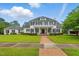 Inviting two-story home featuring a brick pathway, manicured lawn and classic black shutters at 1093 N Lakeside Dr, Smithfield, NC 27577