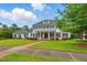 Charming two-story home with black shutters, a brick path, and a beautifully maintained front yard at 1093 N Lakeside Dr, Smithfield, NC 27577