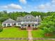 Beautiful two-story home boasts lush lawn, mature landscaping and a covered porch at the main entrance at 1093 N Lakeside Dr, Smithfield, NC 27577
