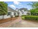 Charming home with a brick path, lush lawn, and mature trees offering shade and curb appeal at 1093 N Lakeside Dr, Smithfield, NC 27577