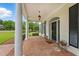 Charming front porch featuring brick flooring, classic columns, and a welcoming entrance at 1093 N Lakeside Dr, Smithfield, NC 27577