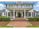 Inviting front porch with brick flooring, stately columns, and elegant entryway at 1093 N Lakeside Dr, Smithfield, NC 27577