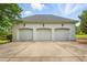 Three-car garage with white doors and concrete driveway at 1093 N Lakeside Dr, Smithfield, NC 27577