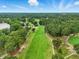 Aerial view of lush golf course and surrounding greenery, offering a scenic view for homeowners at 1093 N Lakeside Dr, Smithfield, NC 27577