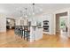 Bright kitchen features an island with seating, stainless appliances, and hardwood flooring at 1093 N Lakeside Dr, Smithfield, NC 27577