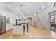 Open concept kitchen featuring island seating, hardwood floors, and sleek white cabinets at 1093 N Lakeside Dr, Smithfield, NC 27577